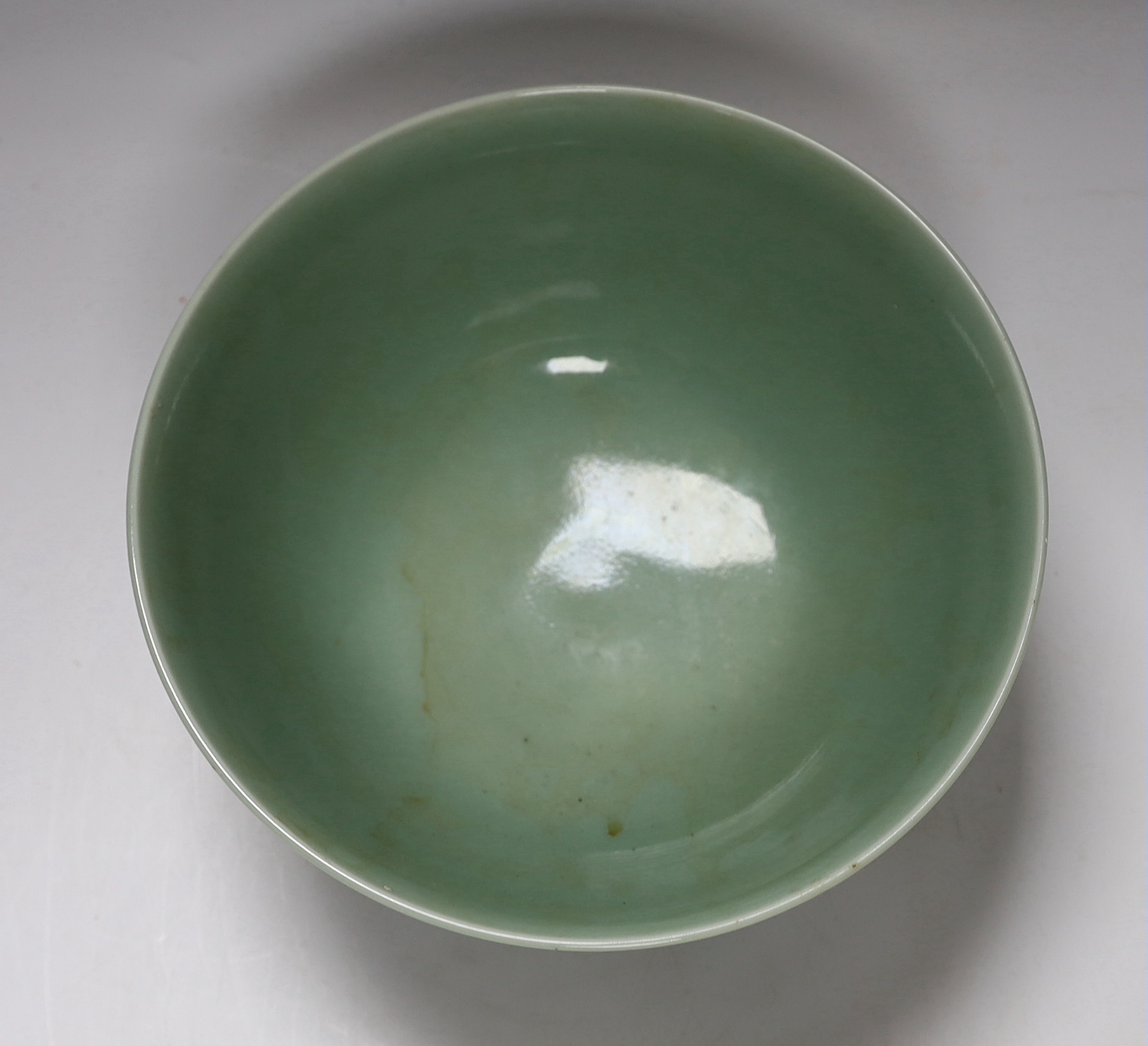 A Chinese celadon glazed ‘lotus’ bowl, 25cm diameter
